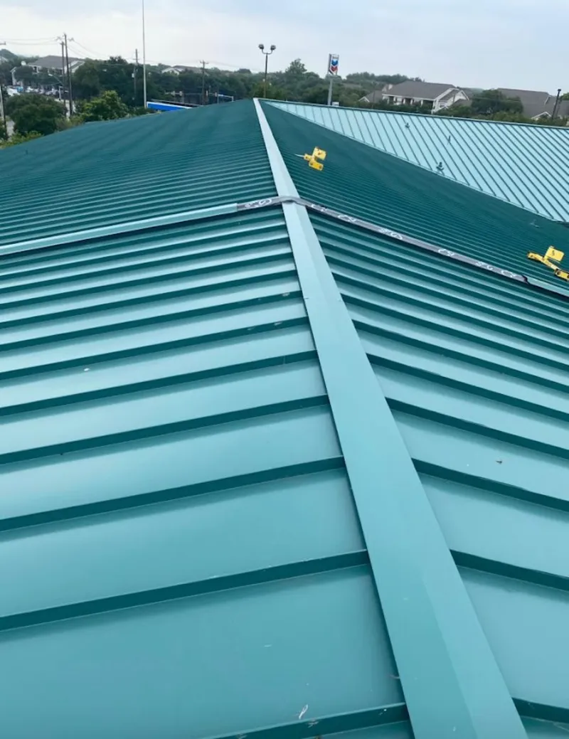 Green commercial metal roof ridge and valley for Metal Roof Repair in Chippewa Falls